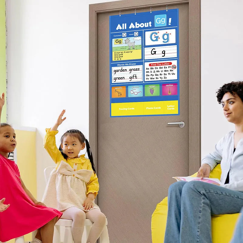 Alphabet learning chart with letter cards, word cards, and picture cards laid out on a table.