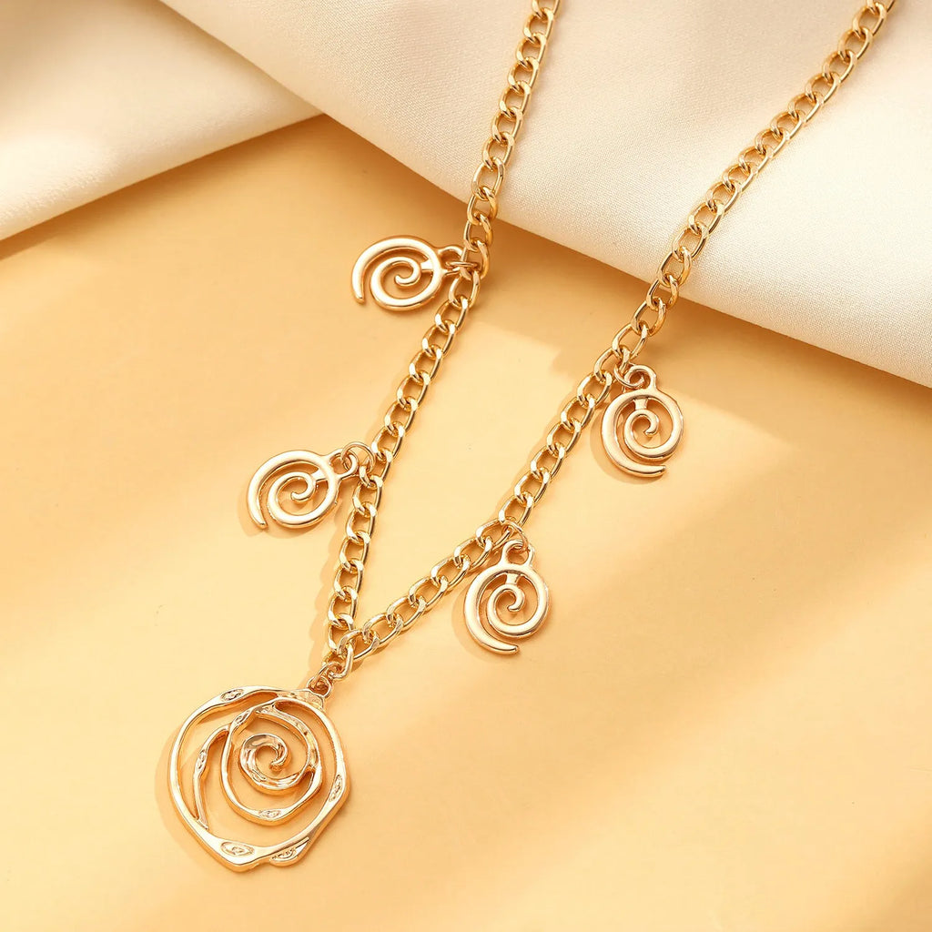 Spiral donut jewellery set showing necklace, bracelet, and earrings in geometric circle design with gold finish
