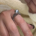 Open finger ring with geometric design, black pearl accent, and adjustable copper band