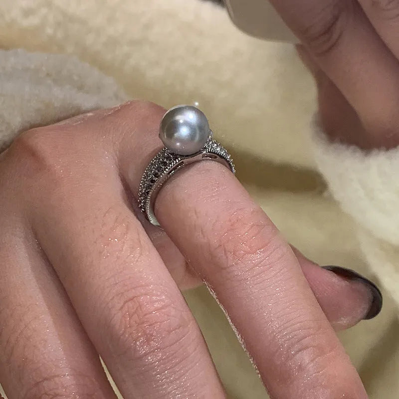 Open finger ring with geometric design, black pearl accent, and adjustable copper band