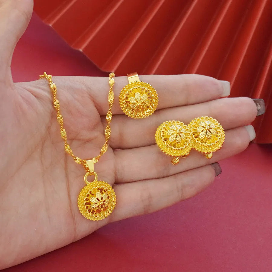 Gold-plated three-piece jewellery set showing necklace with pendant, earrings, and ring with middle eastern flower design