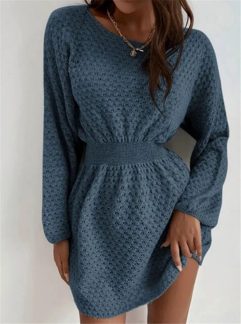 Blue women's knitted dress with white hand-crocheted flower details on the chest, showing a fitted waist and round neck.