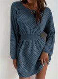 Blue women's knitted dress with white hand-crocheted flower details on the chest, showing a fitted waist and round neck.