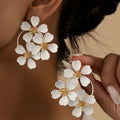 Retro flower earrings for women in black or white with iron construction and baking varnish finish