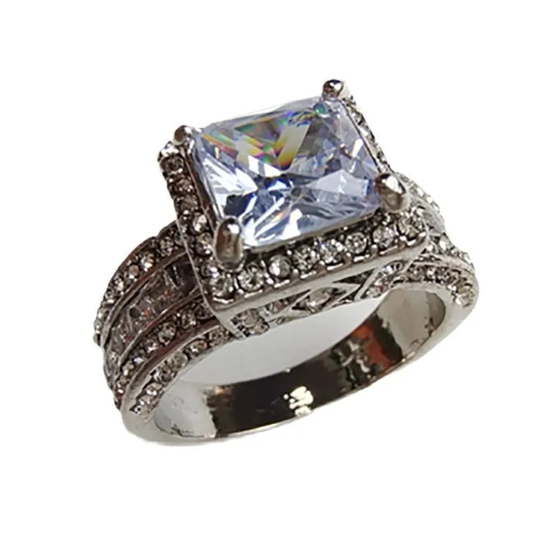 Geometric round women's alloy ring in gold or white electroplated finish.