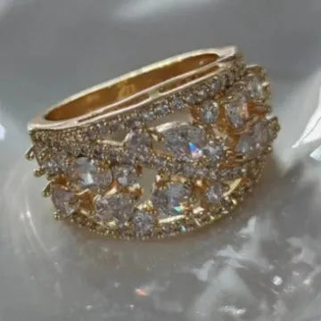 A women's hollow round copper fashion ring shown in a choice of platinum and gold finishes with white or blue accents.