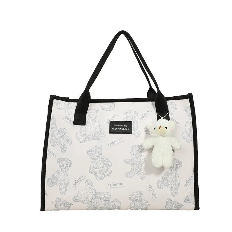 Women's black and white rhombus pattern canvas tote bag with shoulder strap showing horizontal square shape