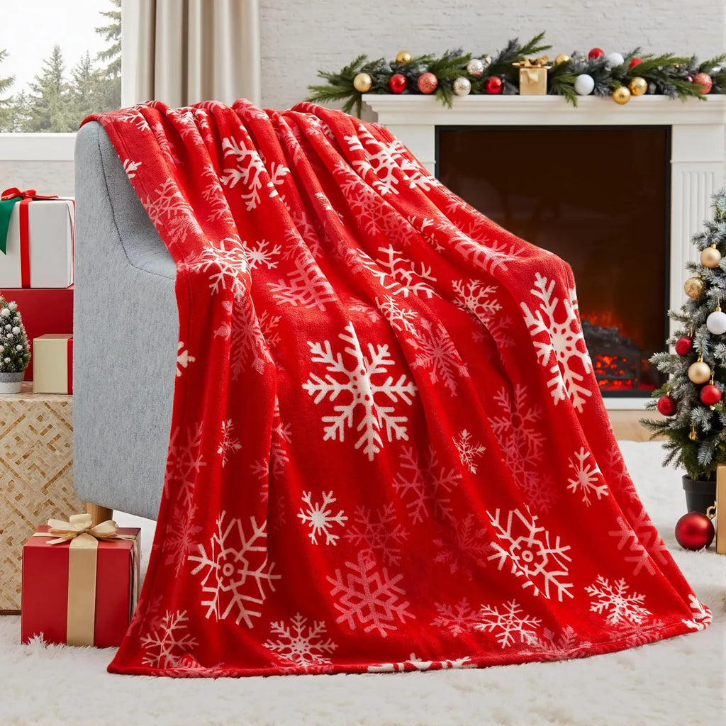 Soft red polyester flannel Christmas blanket folded on a bed