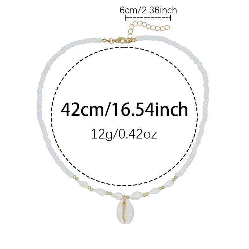 White conch shell bead necklace with a detailed mother pearl shellfish pendant on a regular chain.