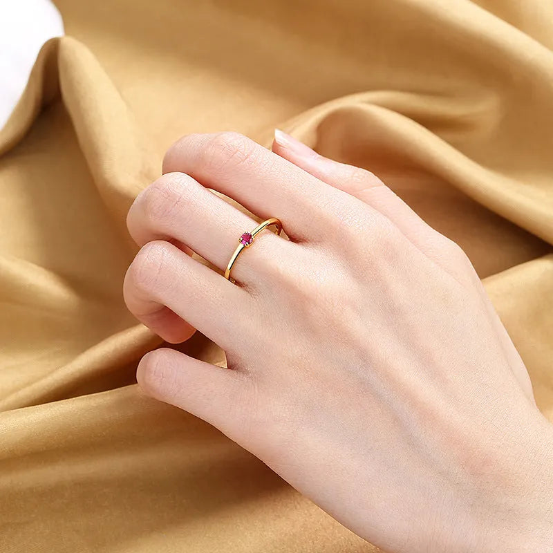 Copper geometric fine circle ring for women with a single diamond, shown in blue colour.