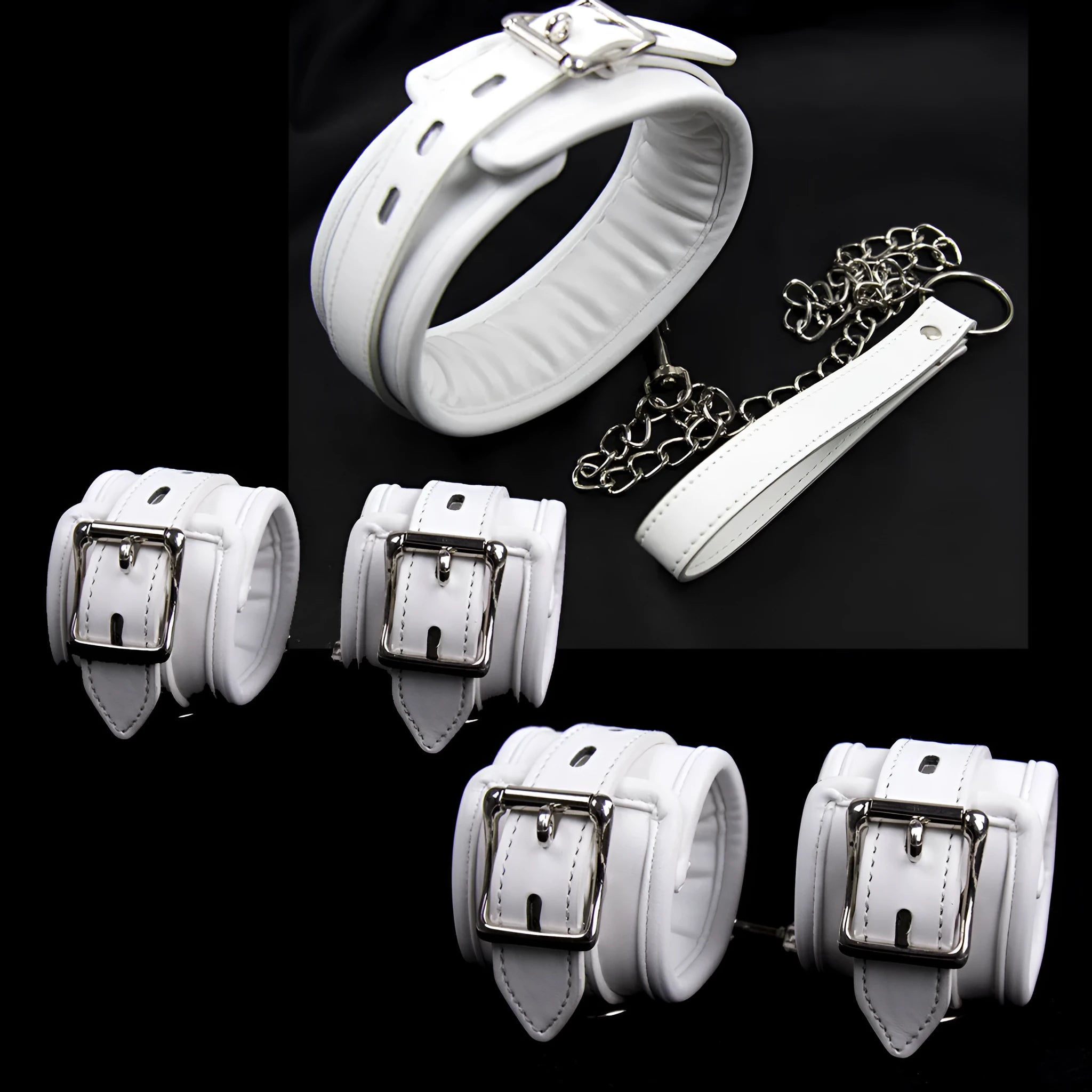 White PU foam bondage set showing handcuffs, ankle cuffs, and a neck scarf on a dark background.