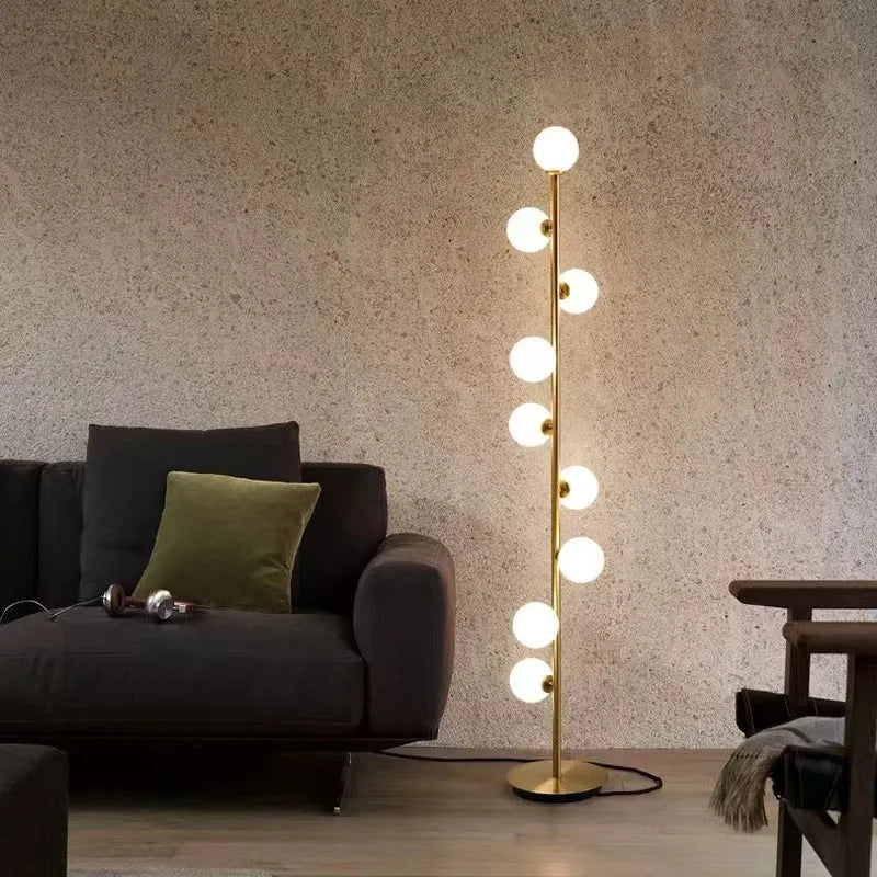 Tall minimalist Nordic style floor lamp with iron frame and glass shade on a stable iron base.