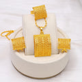 Golden copper bridal jewellery set featuring a necklace, pair of earrings, and a ring on a display.