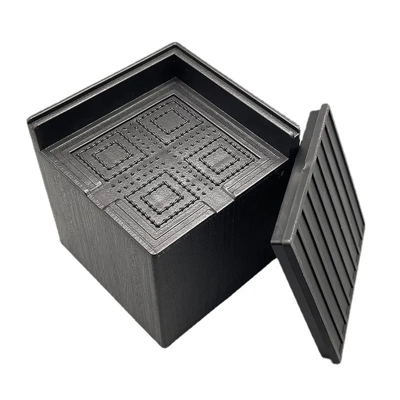 Four black circular plastic foot mats for furniture height increasing.