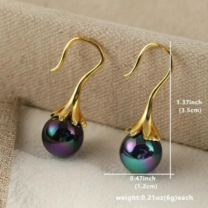 A pair of gold-coloured retro fashion earrings for women, made from electroplated alloy.
