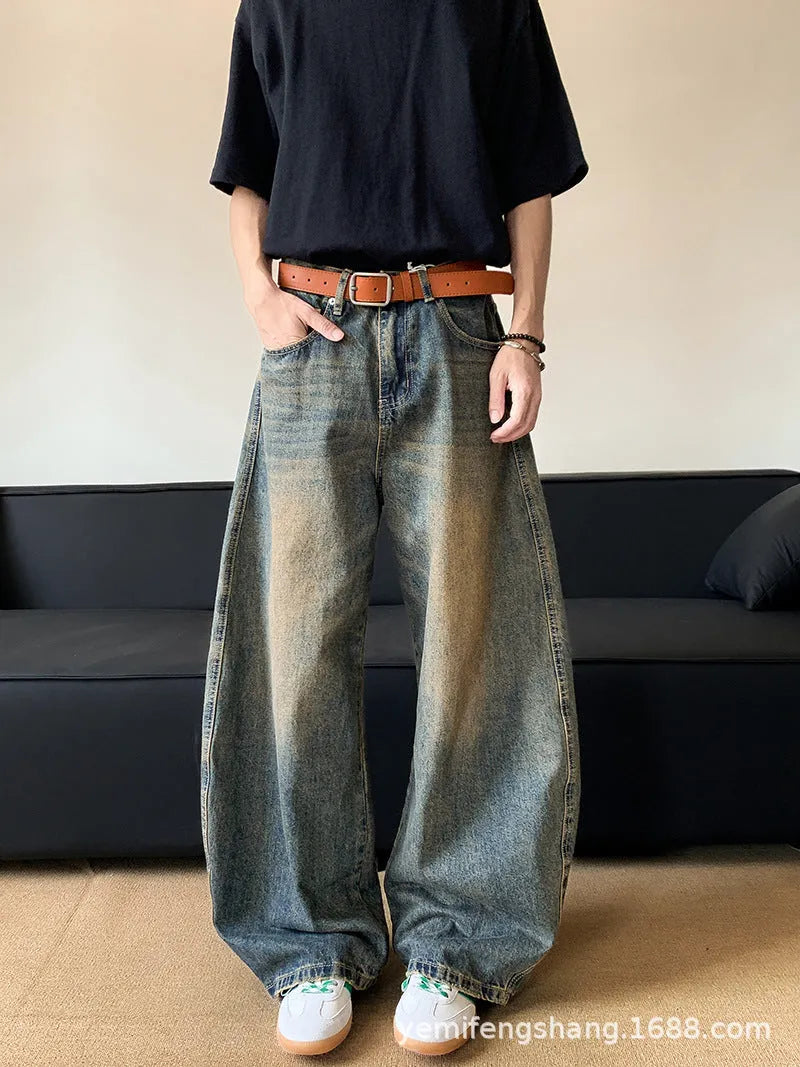 Man wearing retro blue distressed wide-leg denim jeans with machete detailing