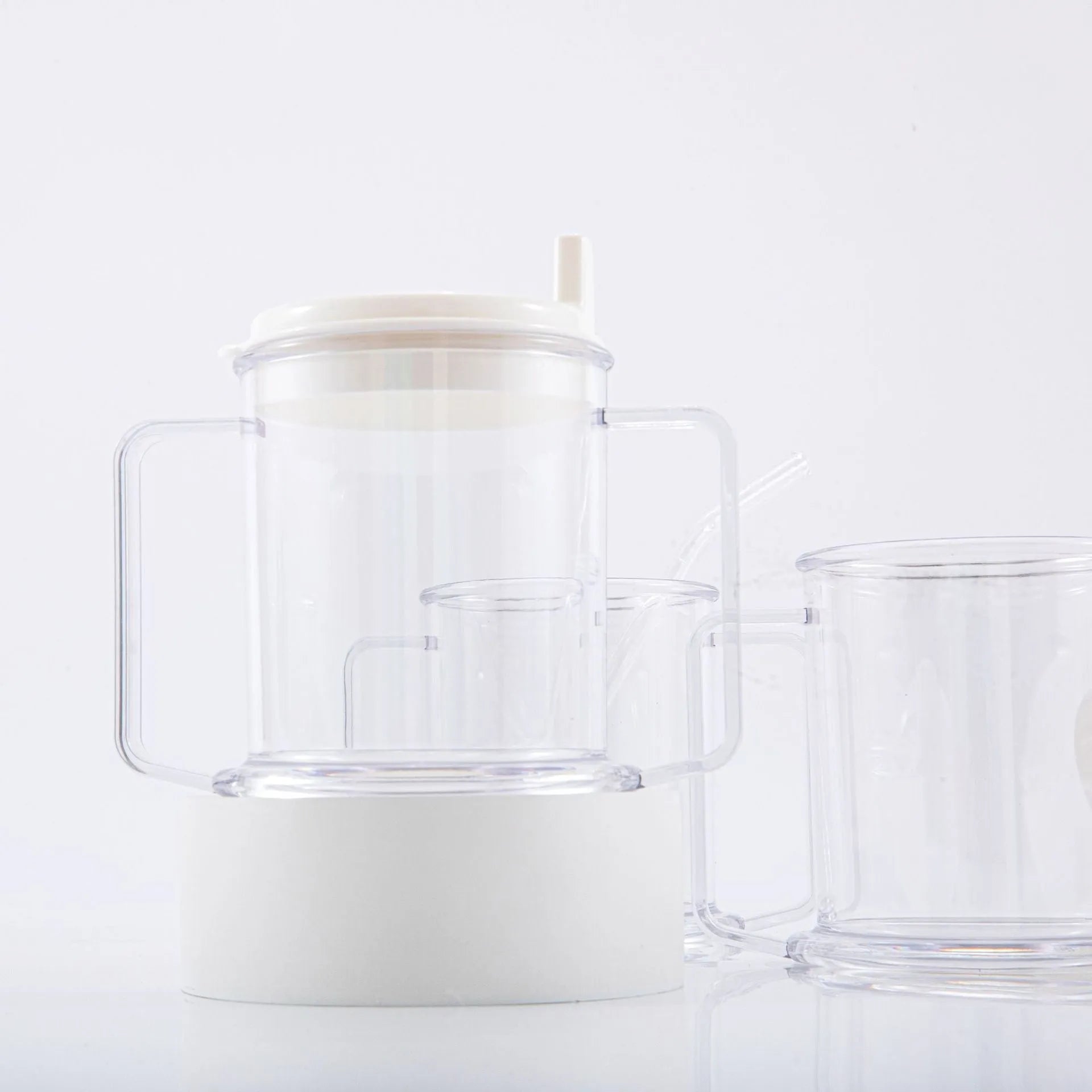 Transparent plastic drinking cup with secure lid showing dimensions and spill-proof design