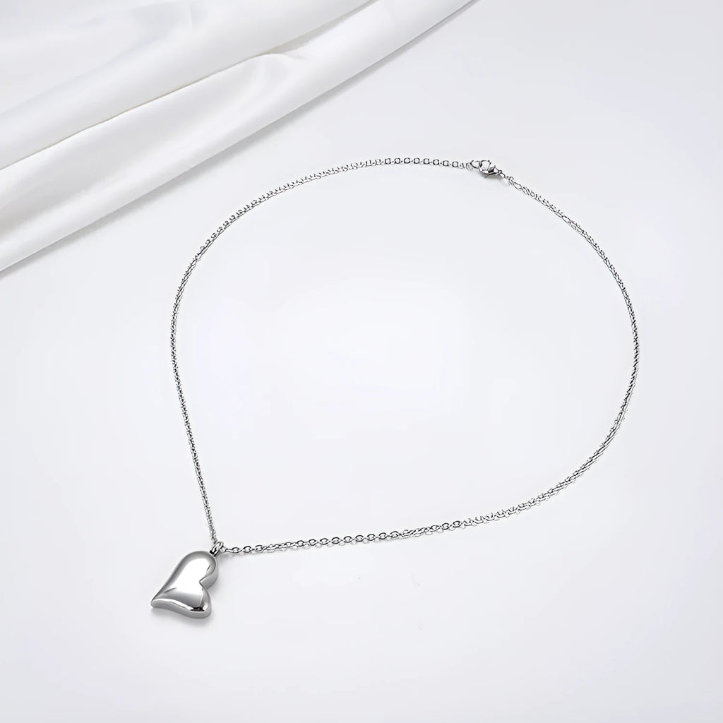 Silver stainless steel necklace with curved peach heart pendant on adjustable chain