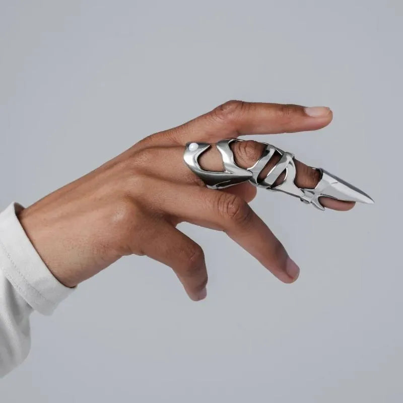 Silver alloy punk armour finger stall fashion ring on a finger.