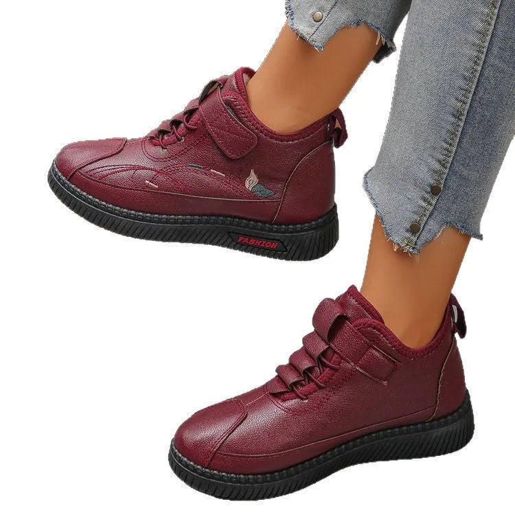 Women's black velvet low-top shoes with a non-slip rubber sole and hollow out design on a white background.