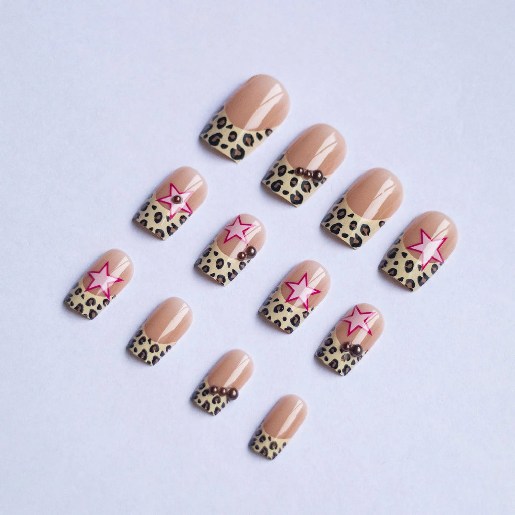 French leopard print nail art with five-pointed stars, pearl and diamond accents on wearable nail pieces