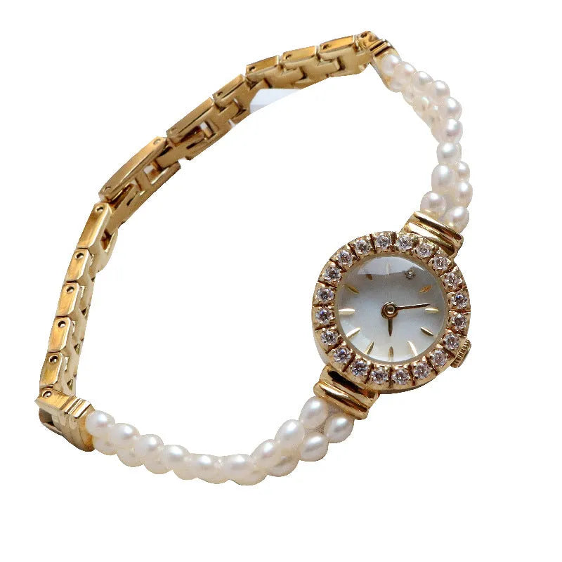 Women's light gold bracelet watch with a freshwater pearl dial and stainless steel strap