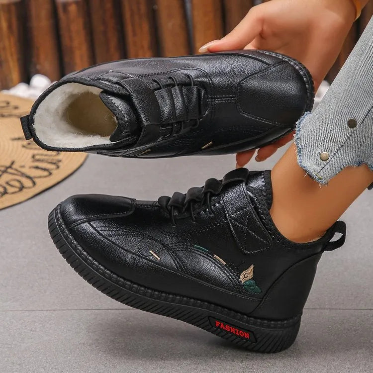 Women's black velvet low-top shoes with a non-slip rubber sole and hollow out design on a white background.