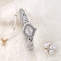 Ladies diamond fashion watch with gold or silver finish and chain strap, showing 7mm thickness and mineral glass face