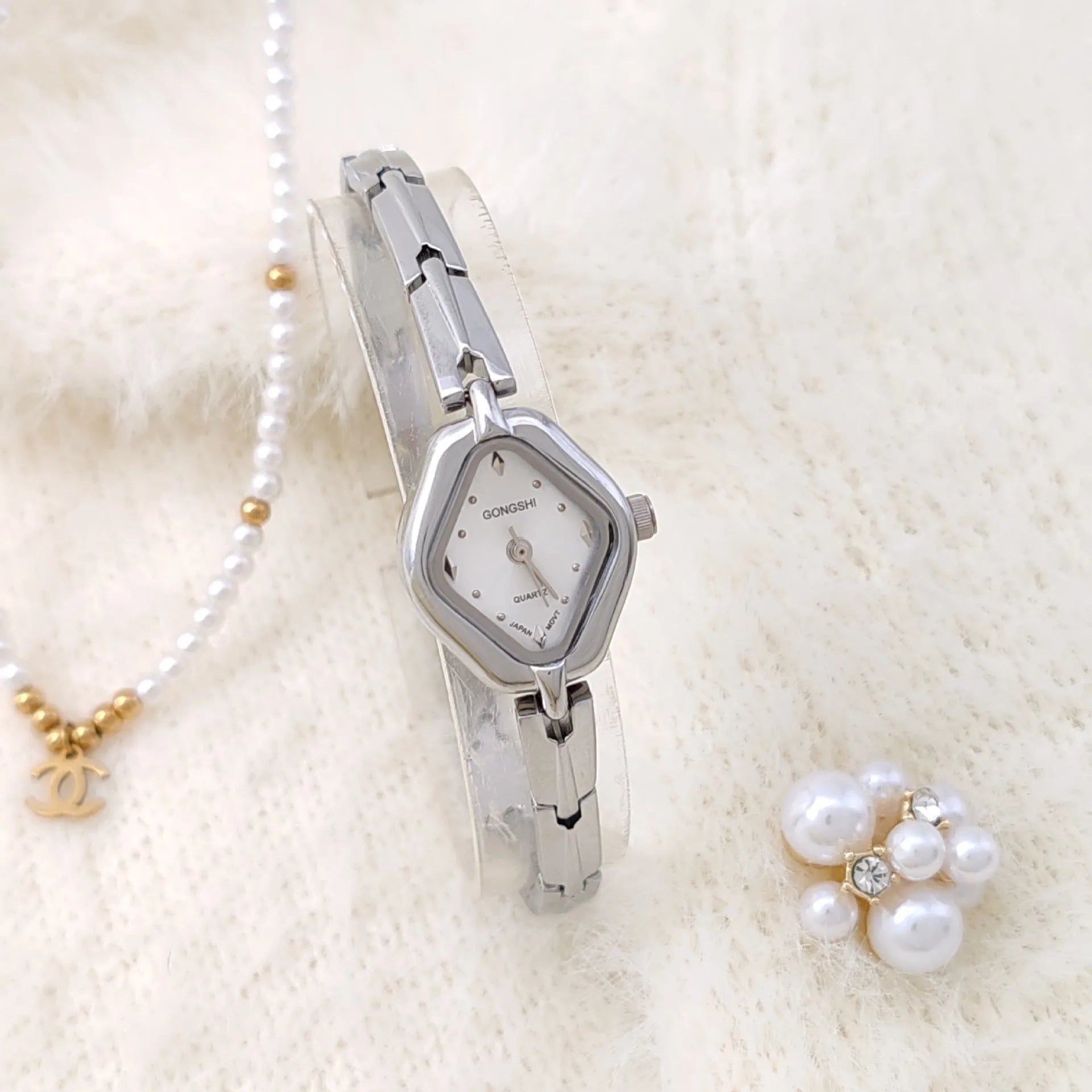 Ladies diamond fashion watch with gold or silver finish and chain strap, showing 7mm thickness and mineral glass face