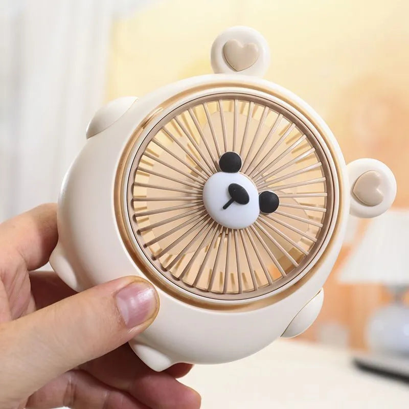 Cute dog-themed desktop electric fan with USB cable and multiple colour options on a desk.