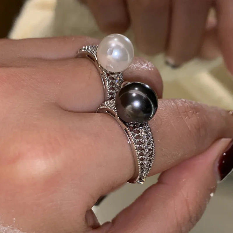 Open finger ring with geometric design, black pearl accent, and adjustable copper band
