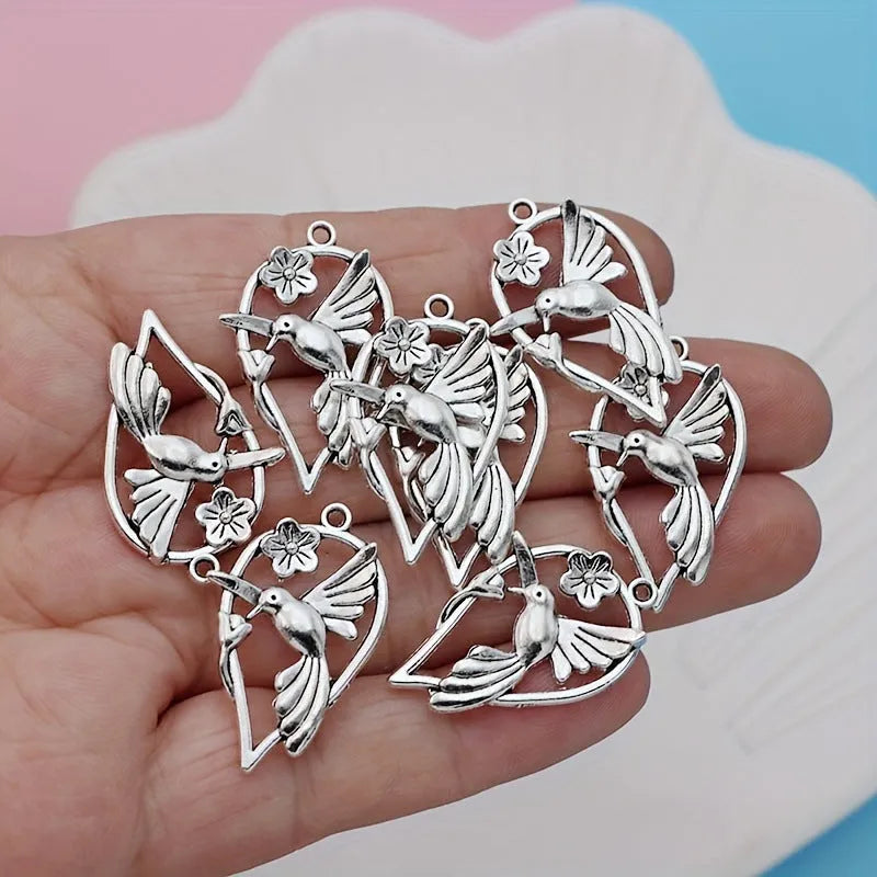 Close-up of an alloy magpie bird pendant charm with electroplated finish for DIY jewellery.