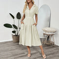 Light green shirt dress with lapel collar, waist tie, and side pockets