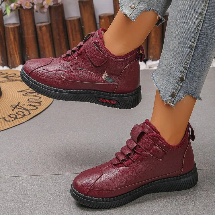 Women's black velvet low-top shoes with a non-slip rubber sole and hollow out design on a white background.