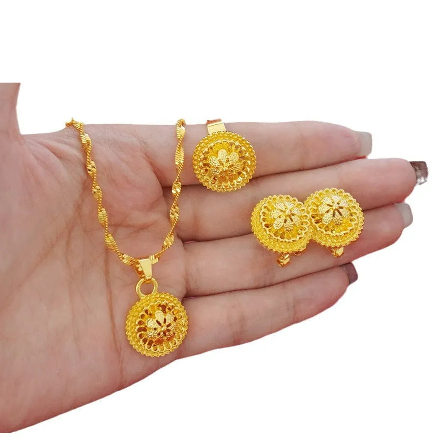 Gold-plated three-piece jewellery set showing necklace with pendant, earrings, and ring with middle eastern flower design
