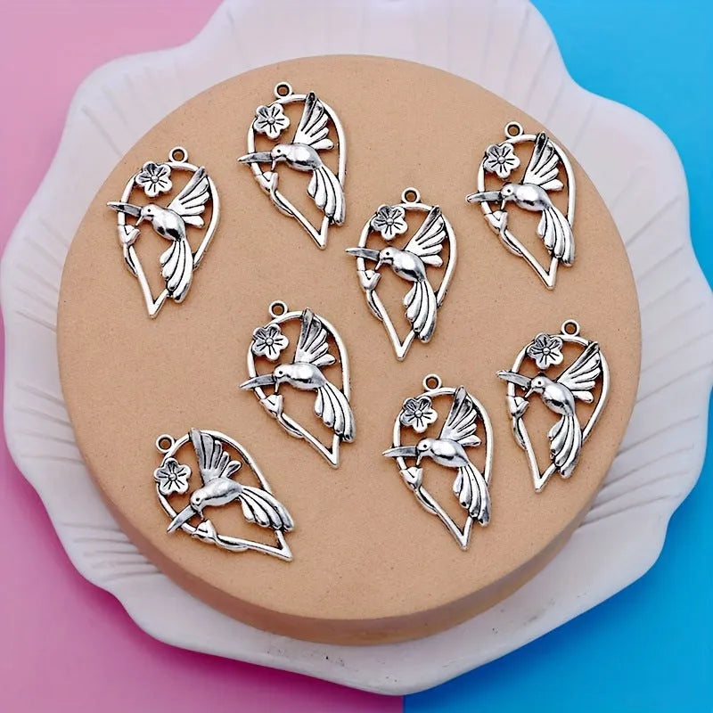 Close-up of an alloy magpie bird pendant charm with electroplated finish for DIY jewellery.