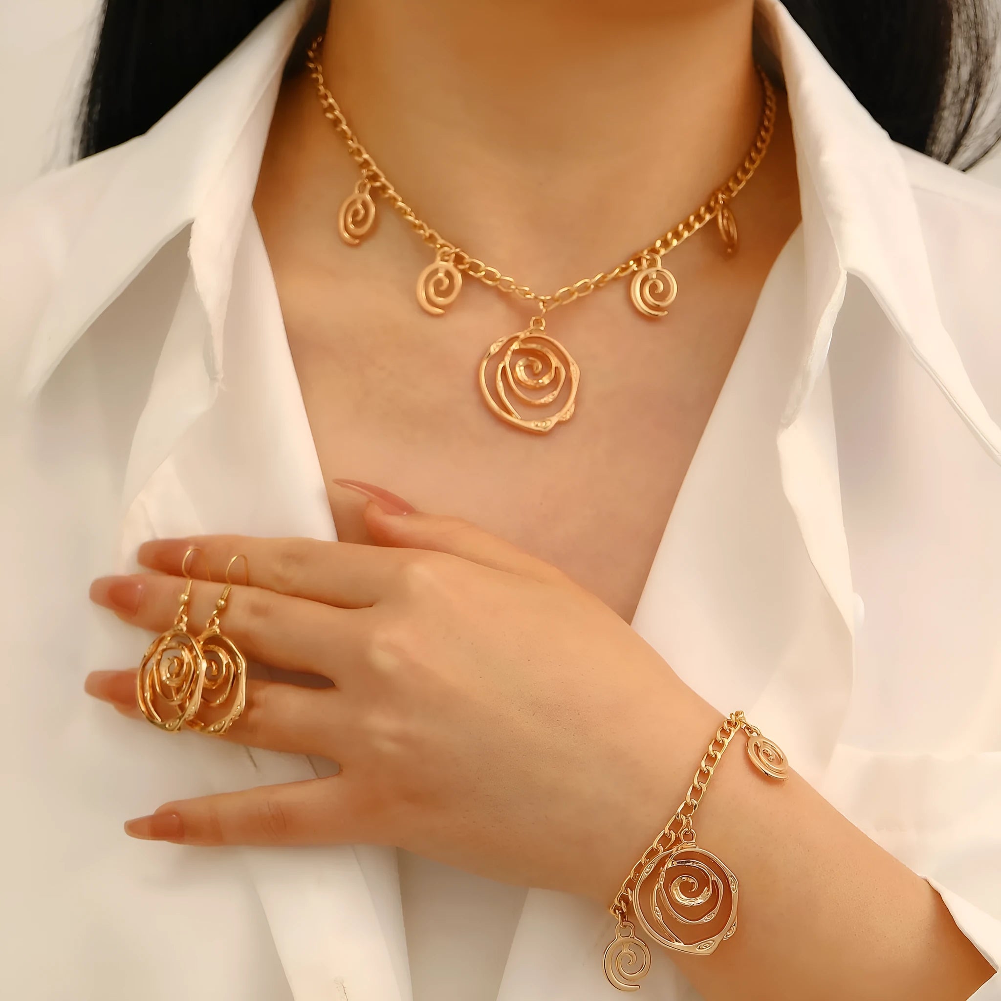Spiral donut jewellery set showing necklace, bracelet, and earrings in geometric circle design with gold finish