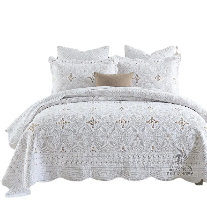 Pure cotton embroidered bed cover set with pillowcases on a double bed.