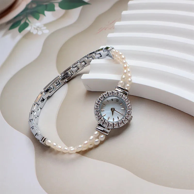 Women's light gold bracelet watch with a freshwater pearl dial and stainless steel strap