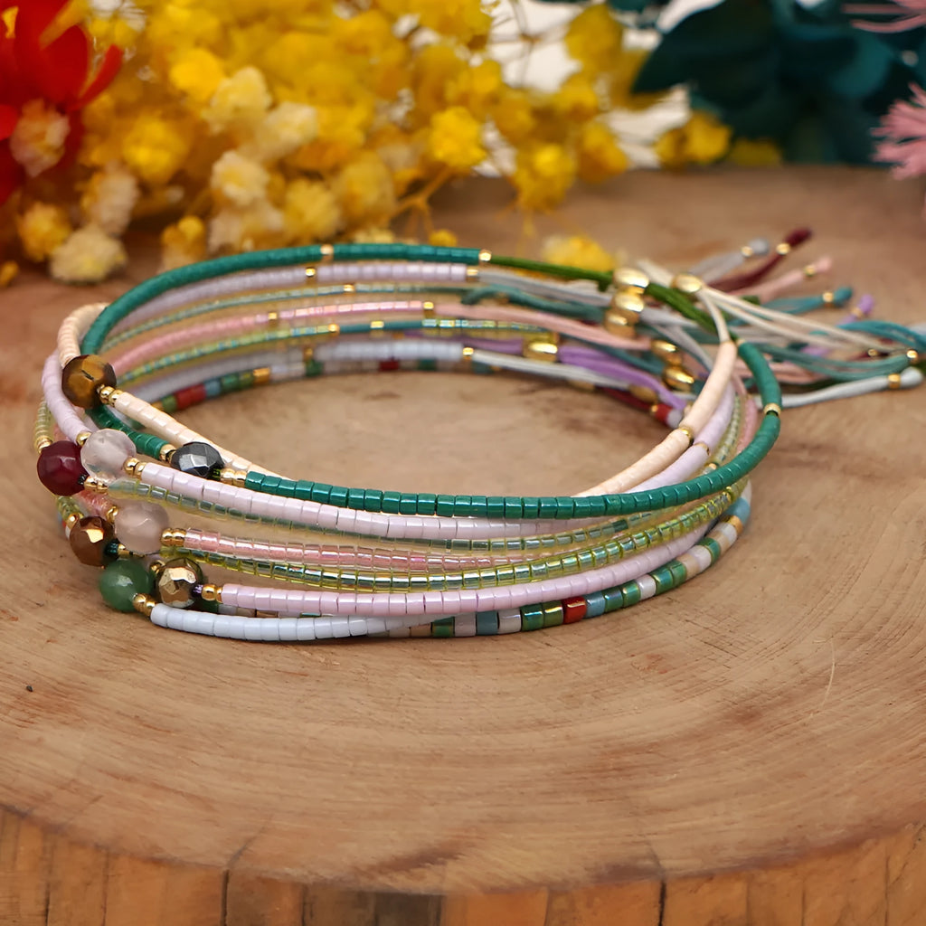 Close-up of a colourful Bohemian-style beaded bracelet featuring semi-precious stone and glass beads on a wrist.