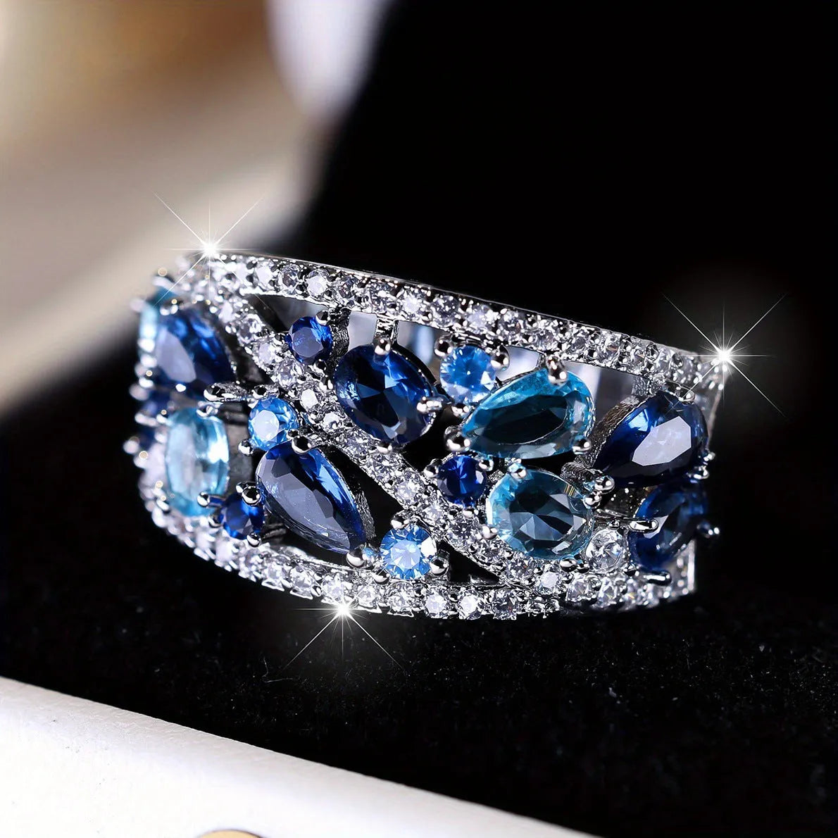 A women's hollow round copper fashion ring shown in a choice of platinum and gold finishes with white or blue accents.