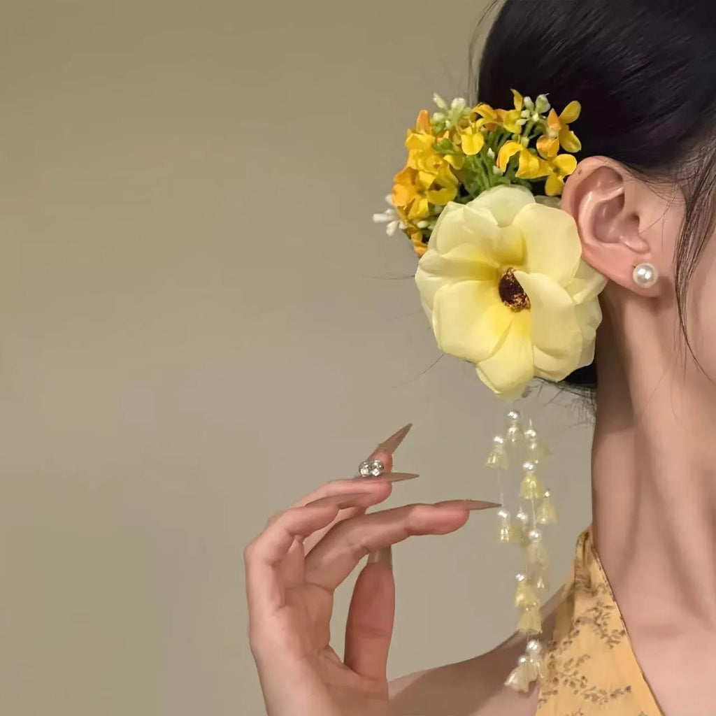 Close-up of a handcrafted women's hair clip with a flower tassel in purple and yellow colour options.