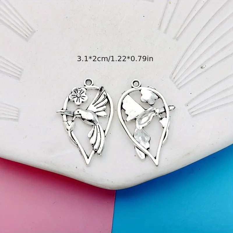 Close-up of an alloy magpie bird pendant charm with electroplated finish for DIY jewellery.