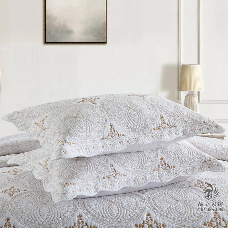Pure cotton embroidered bed cover set with pillowcases on a double bed.