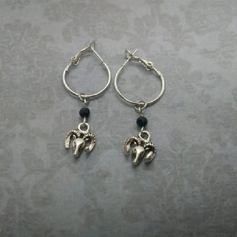 Silver alloy round hoop earrings with a detailed Tibetan antelope silhouette design.