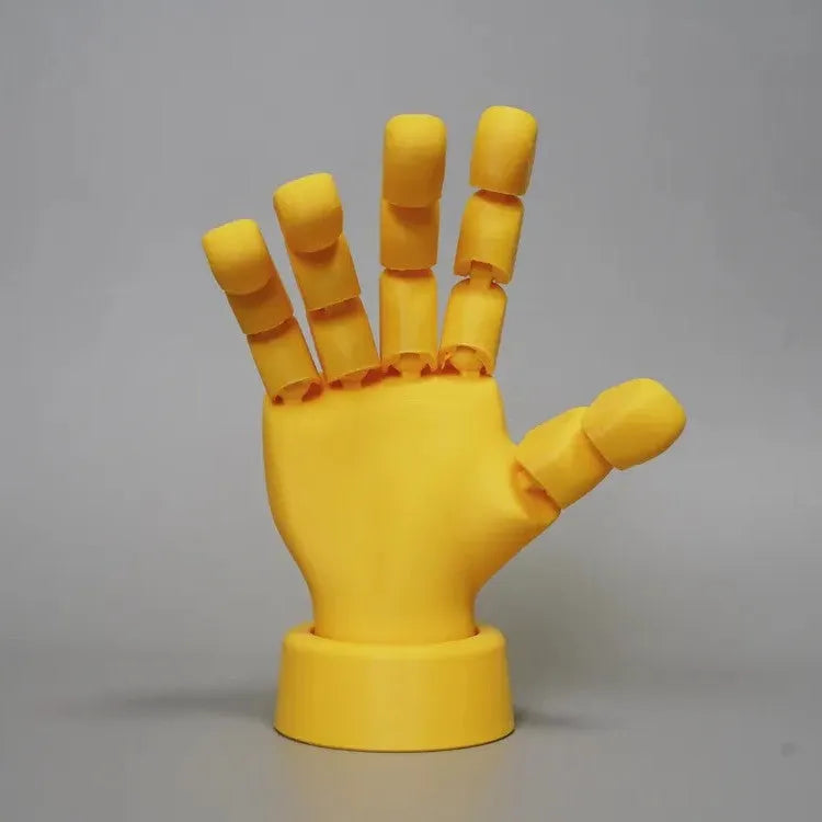 Yellow movable joint hand prop ornament on a white background.