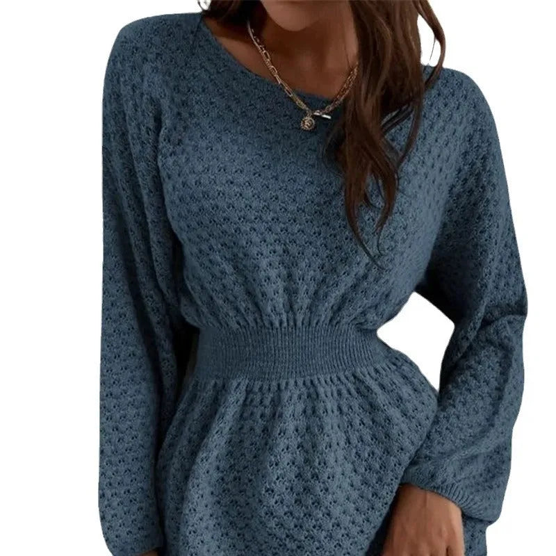 Blue women's knitted dress with white hand-crocheted flower details on the chest, showing a fitted waist and round neck.