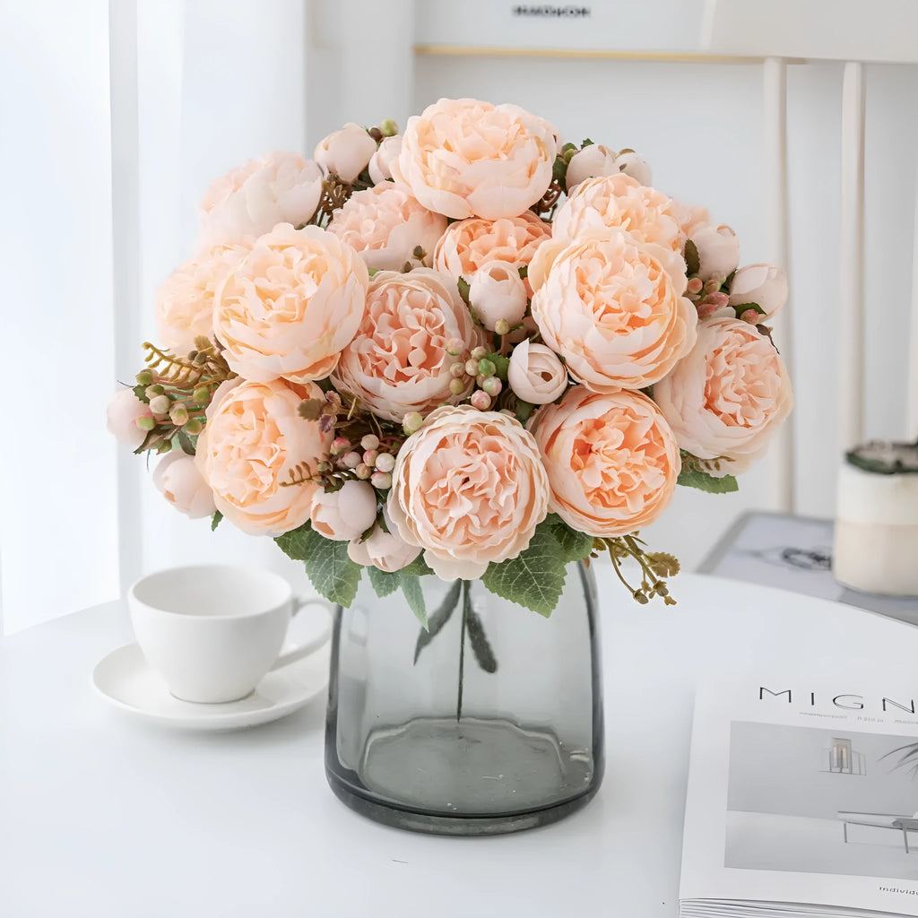 Silk artificial peony bouquet in champagne colour on a table for home or wedding decor.