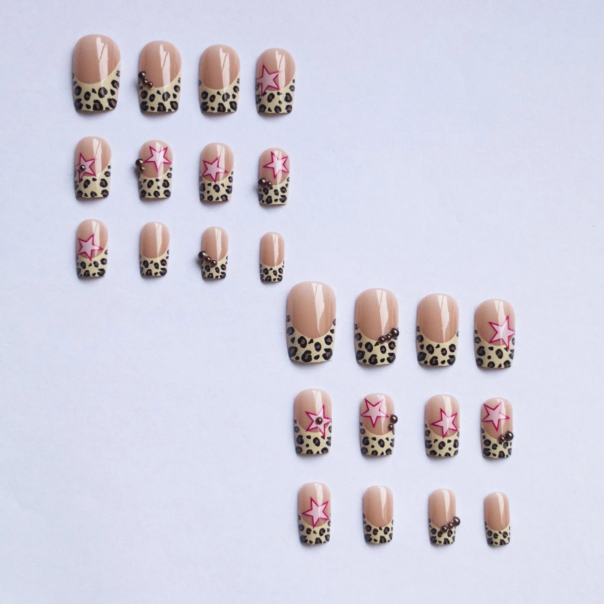 French leopard print nail art with five-pointed stars, pearl and diamond accents on wearable nail pieces