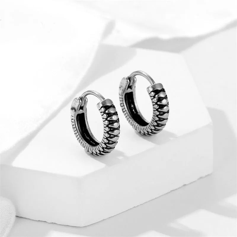 Silver geometric retro twist earrings made from stainless steel with a striped pattern.